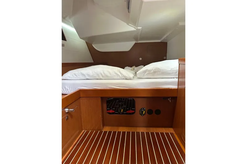 Margaret Yacht Photos Pics Interior cabin of 2014 Beneteau Oceanis 48 yacht with wooden flooring and cozy bed.