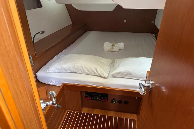 Margaret Yacht Photos Pics Cozy cabin interior of 2014 Beneteau Oceanis 48 yacht with neatly arranged bed.