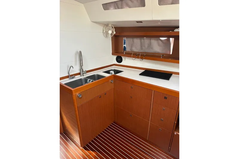 Margaret Yacht Photos Pics 2014 Beneteau Oceanis 48 yacht kitchen with wooden cabinetry and dual sinks.