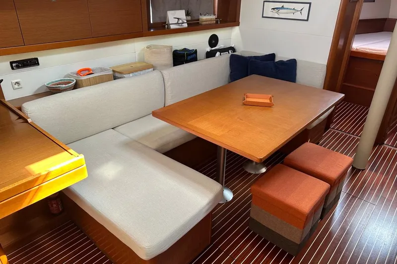 Margaret Yacht Photos Pics Interior of 2014 Beneteau Oceanis 48 yacht with cozy dining area and wooden table.