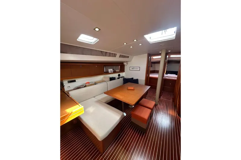 Margaret Yacht Photos Pics Interior of 2014 Beneteau Oceanis 48 yacht, featuring a cozy dining area and modern design.