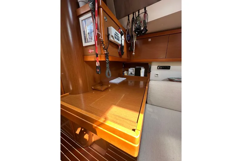 Margaret Yacht Photos Pics Interior of 2014 Beneteau Oceanis 48 yacht with wooden table and storage.