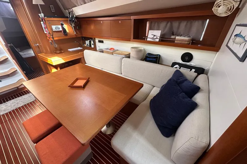 Margaret Yacht Photos Pics Luxurious interior of 2014 Beneteau Oceanis 48 yacht with cozy seating and wooden table.
