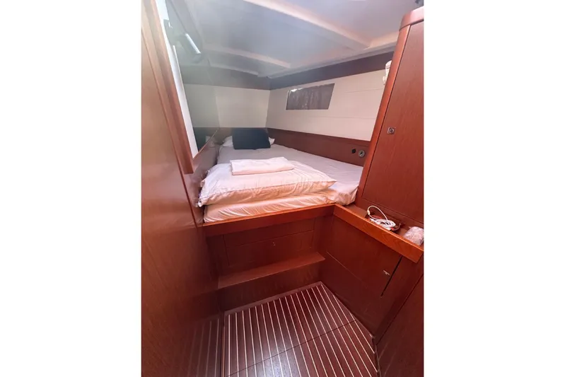 Margaret Yacht Photos Pics Interior cabin of 2014 Beneteau Oceanis 48 yacht with cozy bed and wooden finish.