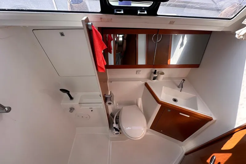 Margaret Yacht Photos Pics Bathroom interior of 2014 Beneteau Oceanis 48 yacht, featuring sink, toilet, and mirror.