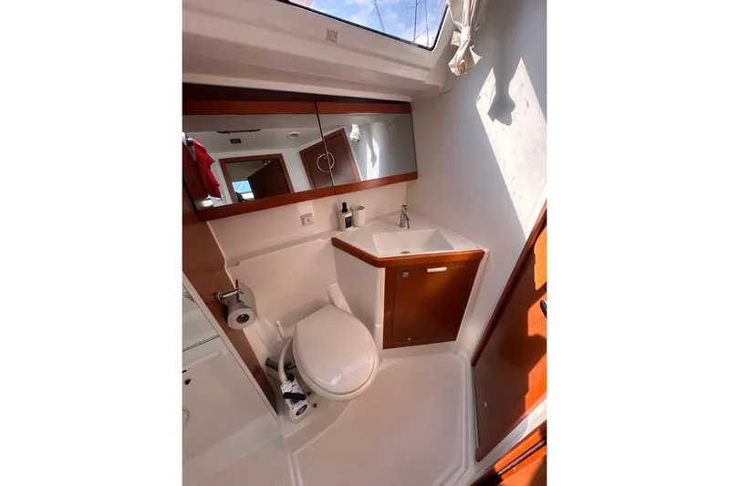 Margaret Yacht Photos Pics 2014 Beneteau Oceanis 48 yacht bathroom with toilet, sink, and mirror.