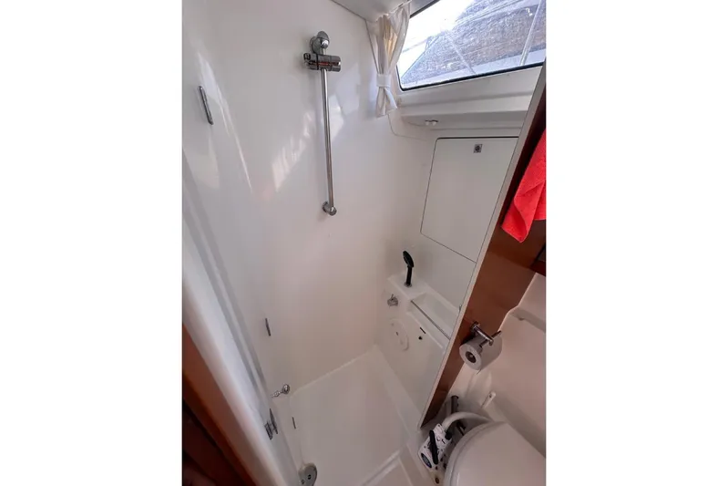 Margaret Yacht Photos Pics 2014 Beneteau Oceanis 48 yacht bathroom with shower, toilet, and window.