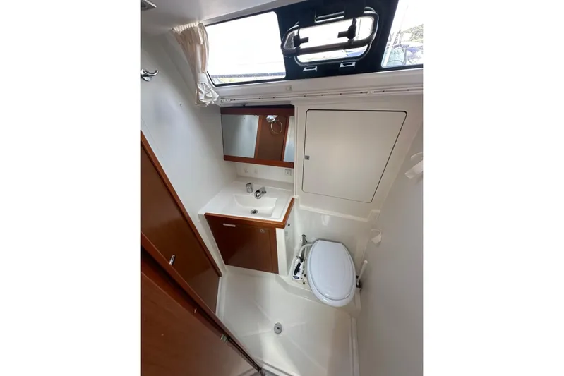 Margaret Yacht Photos Pics Bathroom interior of 2014 Beneteau Oceanis 48 yacht, featuring sink, toilet, and window.