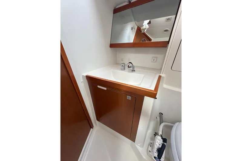 Margaret Yacht Photos Pics Bathroom interior of 2014 Beneteau Oceanis 48 yacht, featuring sink and mirror.