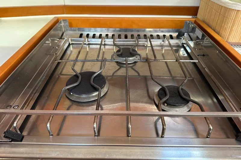 Margaret Yacht Photos Pics Stainless steel stove on 2014 Beneteau Oceanis 48 yacht, featuring three burners.