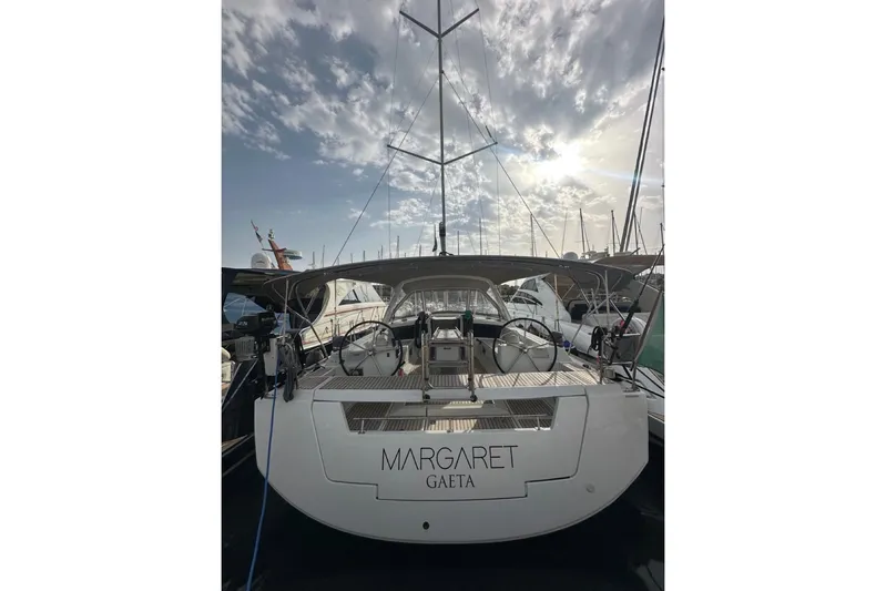 Margaret Yacht Photos Pics 2014 Beneteau Oceanis 48 sailboat docked under a cloudy sky.