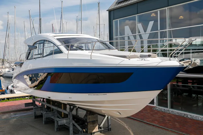  Yacht Photos Pics 2025 Beneteau Gran Turismo 45 yacht displayed at a marina showroom.