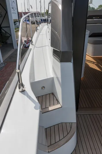  Yacht Photos Pics 2025 Beneteau Gran Turismo 45 yacht deck with sleek design and wooden steps.