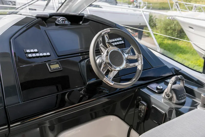  Yacht Photos Pics Helm of 2025 Beneteau Gran Turismo 45 yacht with modern controls and sleek design.