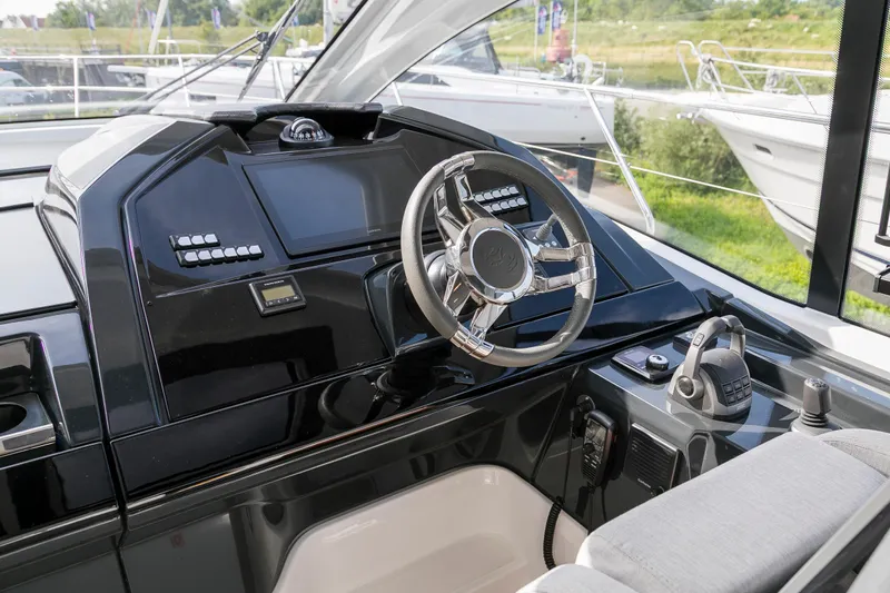  Yacht Photos Pics Helm of 2025 Beneteau Gran Turismo 45 yacht with modern controls and steering wheel.