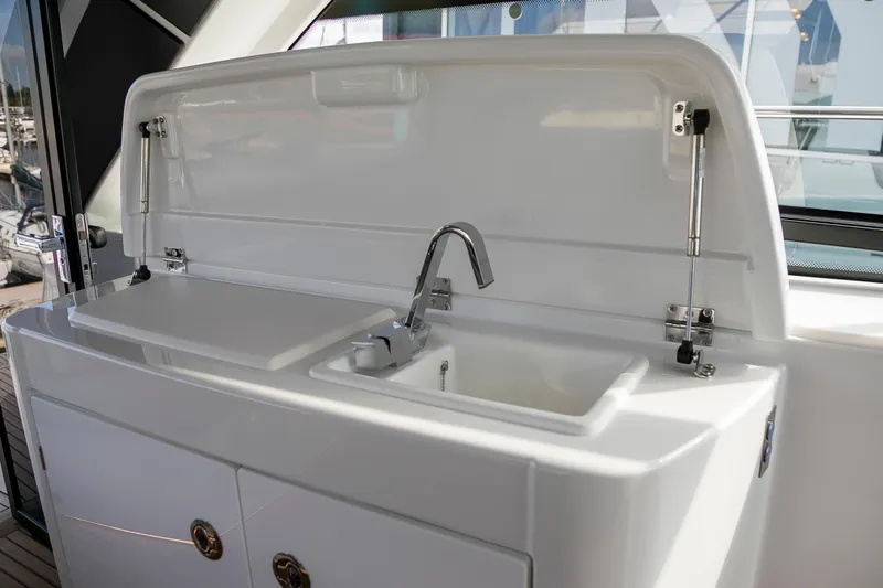  Yacht Photos Pics 2025 Beneteau Gran Turismo 45 yacht kitchenette with sink and storage.