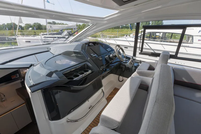  Yacht Photos Pics Interior of 2025 Beneteau Gran Turismo 45 yacht, featuring modern helm and seating area.