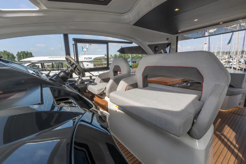  Yacht Photos Pics 2025 Beneteau Gran Turismo 45 yacht interior with modern seating and steering wheel.