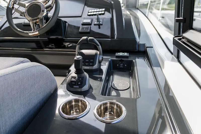  Yacht Photos Pics 2025 Beneteau Gran Turismo 45 helm with joystick controls and cup holders.