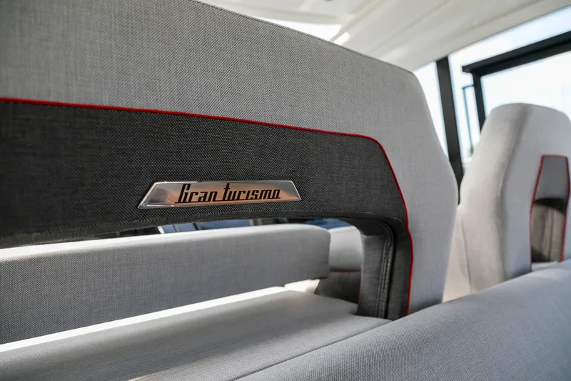  Yacht Photos Pics Interior seating of 2025 Beneteau Gran Turismo 45 yacht, featuring modern design and branding.