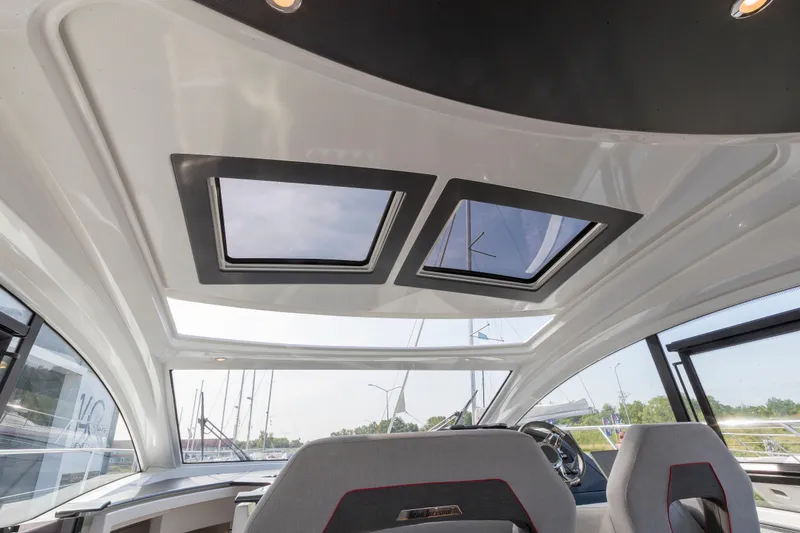  Yacht Photos Pics Interior view of 2025 Beneteau Gran Turismo 45 yacht with skylights and modern seating.