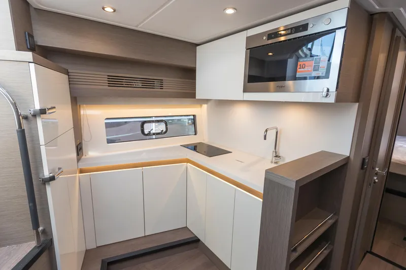  Yacht Photos Pics Modern kitchen in 2025 Beneteau Gran Turismo 45 yacht, featuring sleek cabinetry and built-in appliances.