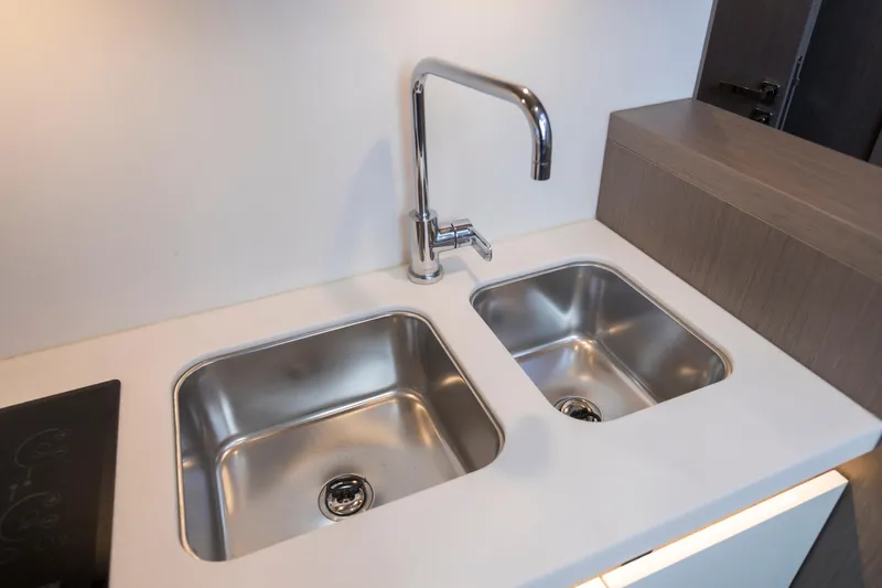  Yacht Photos Pics Modern dual sink setup in 2025 Beneteau Gran Turismo 45 yacht kitchen.