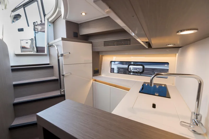  Yacht Photos Pics Modern kitchen interior of 2025 Beneteau Gran Turismo 45 yacht, featuring sleek design and compact layout.