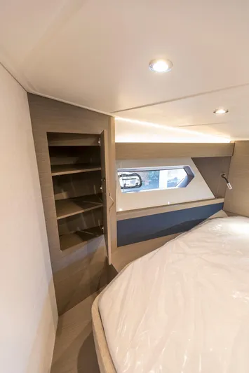  Yacht Photos Pics Luxurious cabin interior of 2025 Beneteau Gran Turismo 45 yacht with modern design and shelving.