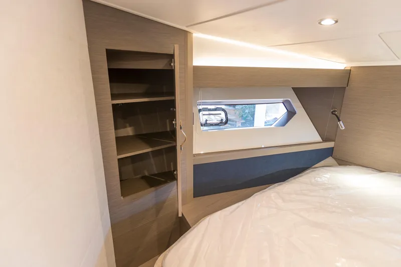  Yacht Photos Pics 2025 Beneteau Gran Turismo 45 cabin interior with storage and window.