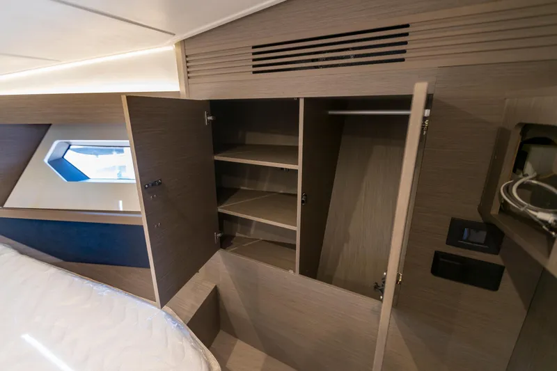  Yacht Photos Pics 2025 Beneteau Gran Turismo 45 interior cabin with open wooden storage cabinets.