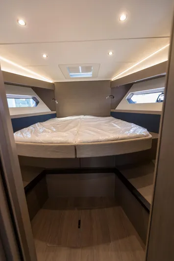  Yacht Photos Pics Luxurious cabin interior of 2025 Beneteau Gran Turismo 45 yacht, featuring modern design and ambient lighting.