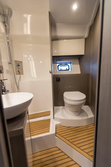  Yacht Photos Pics 2025 Beneteau Gran Turismo 45 yacht bathroom with modern fixtures and wooden flooring.