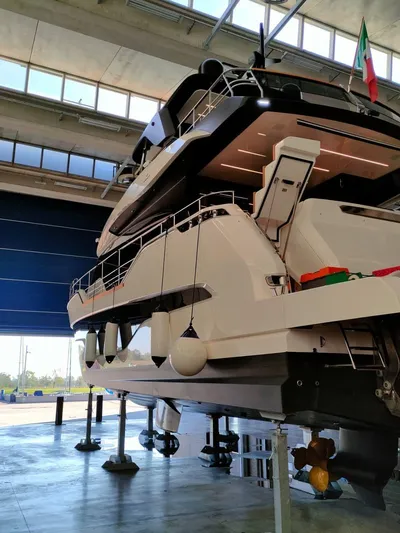 Yacht Photos Pics 2022 Cranchi Sessantasette 67 yacht in a boatyard, showcasing its sleek design and modern features.