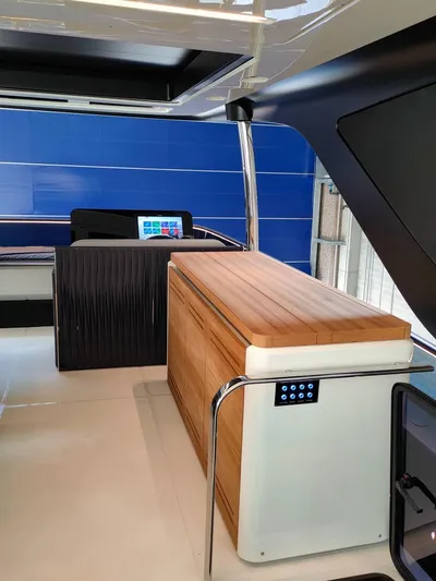  Yacht Photos Pics 2022 Cranchi Sessantasette 67 yacht interior with modern design and sleek wooden accents.