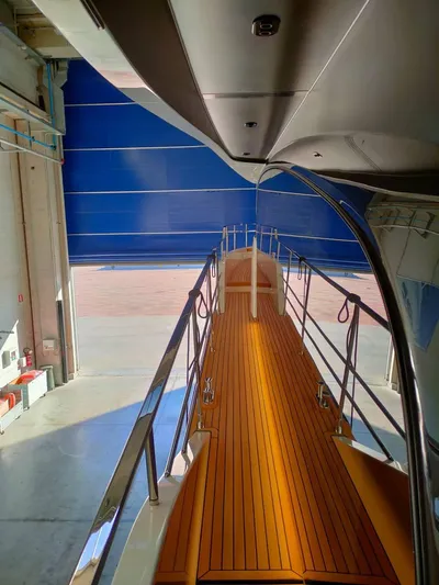  Yacht Photos Pics Cranchi Sessantasette 67 yacht, 2022 model, featuring sleek deck design in a modern marina setting.