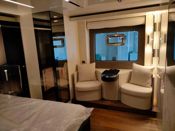  Yacht Photos Pics Luxurious interior of 2022 Cranchi Sessantasette 67 yacht with elegant seating and window view.