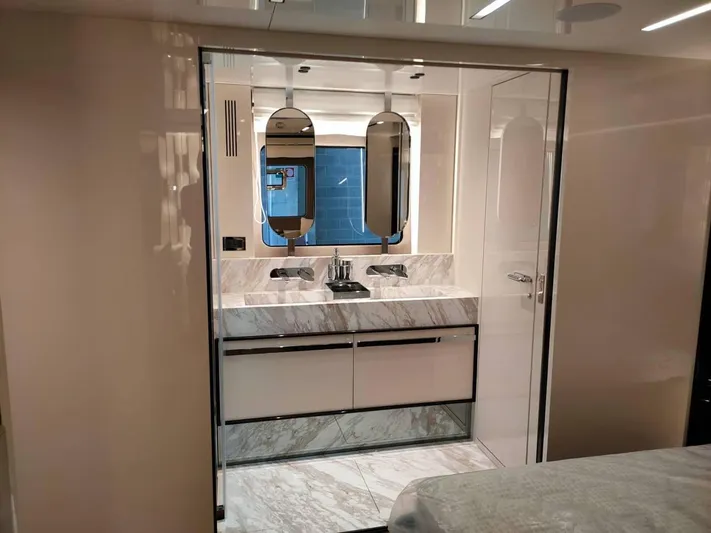  Yacht Photos Pics Luxurious bathroom interior of 2022 Cranchi Sessantasette 67 yacht with marble accents.