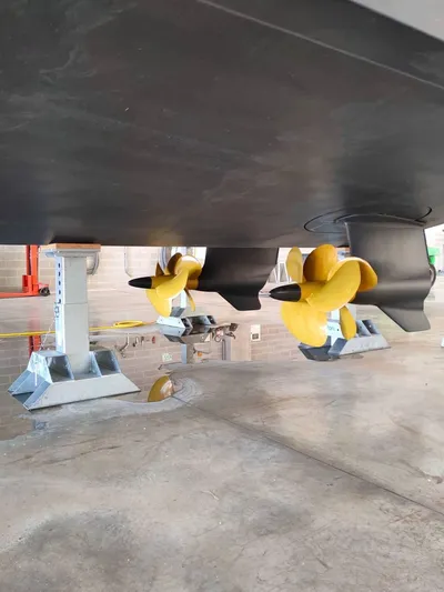  Yacht Photos Pics Close-up of 2022 Cranchi Sessantasette 67 yacht propellers in a workshop setting.