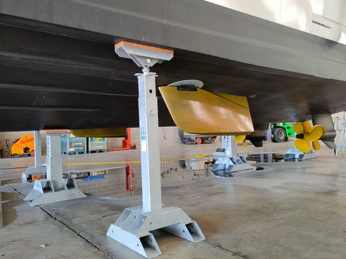  Yacht Photos Pics 2022 Cranchi Sessantasette 67 yacht hull in maintenance, supported by stands in a workshop.