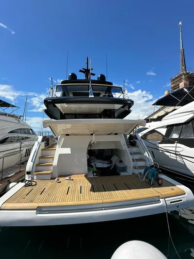  Yacht Photos Pics 2022 Cranchi Sessantasette 67 yacht docked, showcasing rear deck and sleek design.