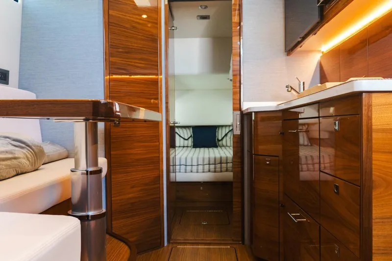Galati Yacht Sales Trade Yacht Photos Pics Luxurious interior of 2024 Valhalla Boatworks V-55 with wood finishes and modern amenities.