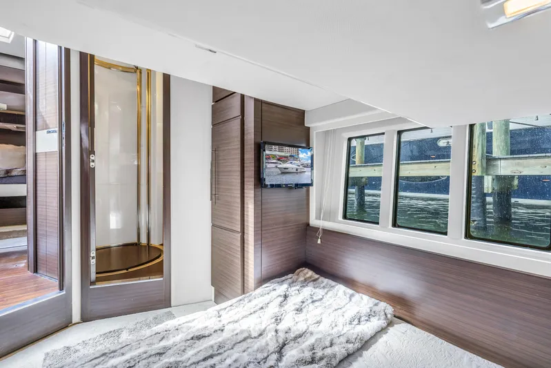 Liquidity Yacht Photos Pics Luxurious bedroom interior of 2012 Azimut 48 Flybridge yacht with water view.