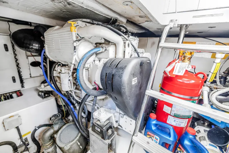 Liquidity Yacht Photos Pics Engine room of a 2012 Azimut 48 Flybridge yacht with equipment and fire extinguisher.