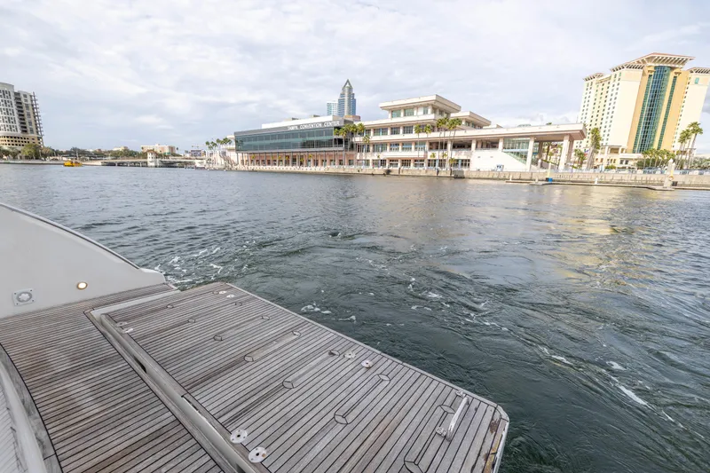 Liquidity Yacht Photos Pics 2012 Azimut 48 Flybridge yacht docked near waterfront buildings.