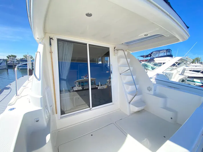  Yacht Photos Pics 2004 Meridian 381 Sedan yacht with sliding glass door and marina view.