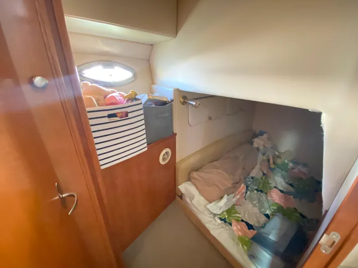  Yacht Photos Pics Cozy cabin interior of 2004 Meridian 381 Sedan with storage and bedding.