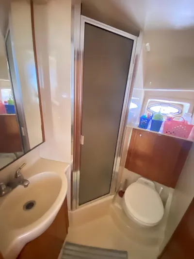  Yacht Photos Pics Bathroom interior of 2004 Meridian 381 Sedan yacht with shower, sink, and toilet.
