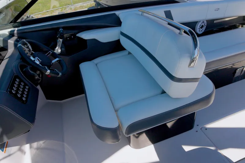  Yacht Photos Pics 2017 Regal 29 OBX boat interior with steering wheel and cushioned seating.