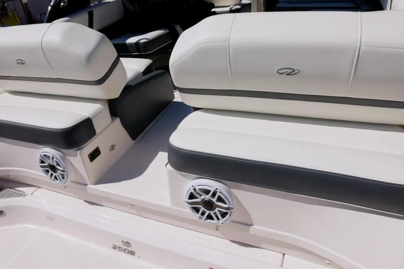  Yacht Photos Pics 2017 Regal 29 OBX boat interior with white cushioned seating and built-in speakers.